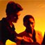 Man and Woman Working With Sunset Behind Them