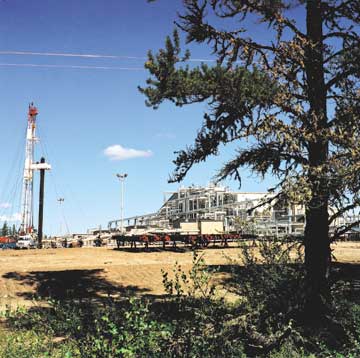 Tar on Tap - The rig on the left is drilling into a thick slab of oil sand hundreds of meters below the ground