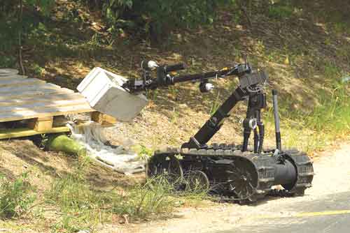 The Drone Warrior - A QinetiQ Talon robot moves a cinder block