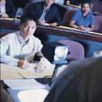 Student Taking Notes In Lecture