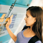 Female Student With Hand On Bulletin Board