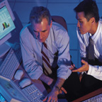 Two Business Men Working At Computer