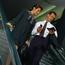 Business Man and Woman Riding Escalator
