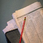 Paper Showing Stocks With Pencil
