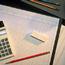 Desktop With Pencil and Calculator