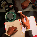 Shaking Hands Over Desk