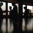 Silhouettes Around Conference Table