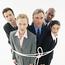 Group Of Business People Tied Up In A Rope