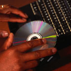 Hands Inserting Disk