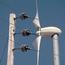 Powerline In Front Of Wind Turbine